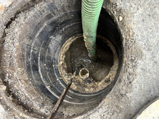 Clearing a clogged line with a hose